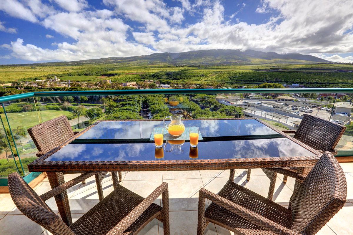 Private lanai with seating and mountain views at Honua Kai penthouse